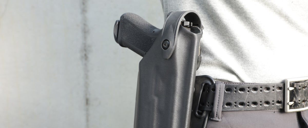 handgun sitting on a holster on a belt